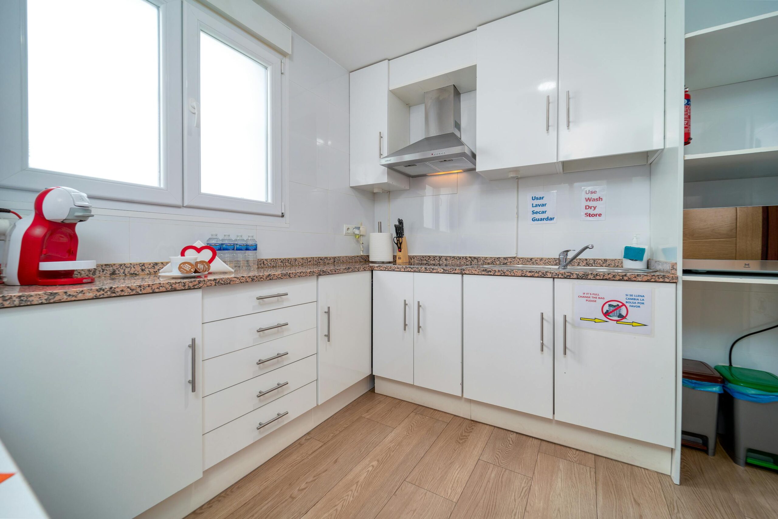 Maple Grove Contemporary white kitchen featuring minimalist design with granite countertops and white cabinets.