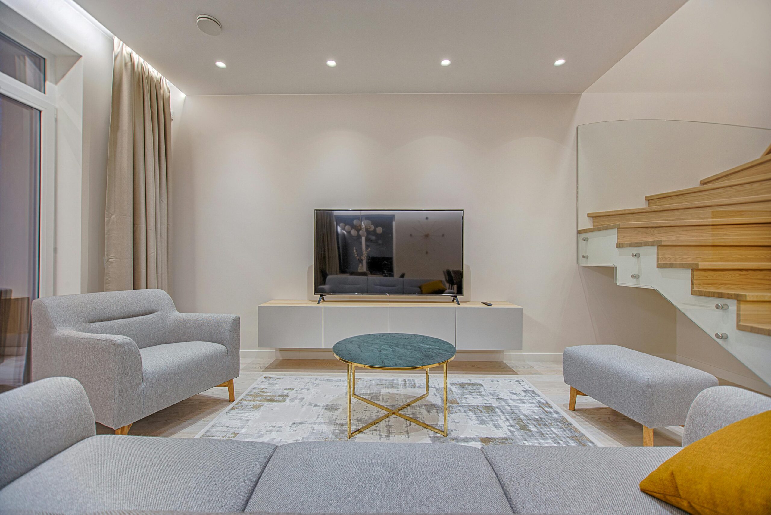 Palm Vista Stylish minimalist living room with modern furniture and warm lighting.