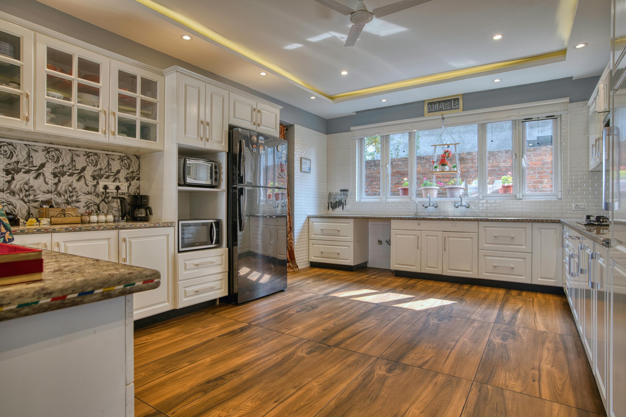 Sunset Haven Bright and spacious modern kitchen with white cabinets in Jammu and Kashmir home.