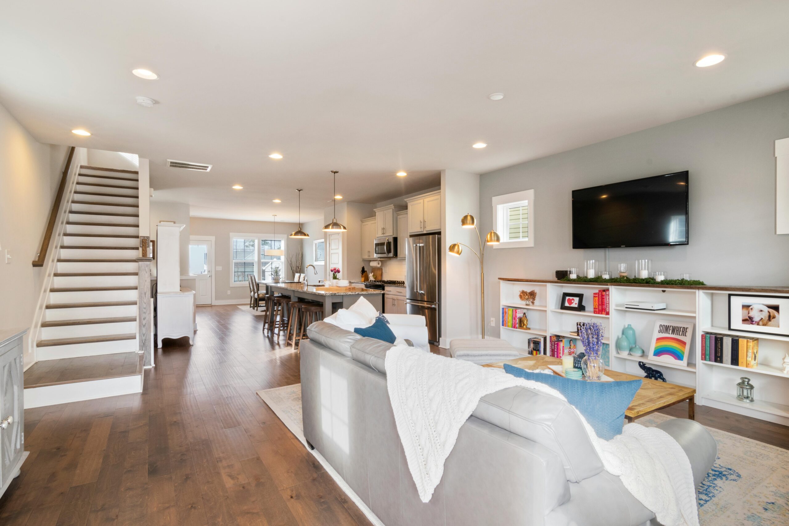 Maple Grove Bright and spacious modern living room with open concept kitchen and dining area, ideal for interior design inspiration.