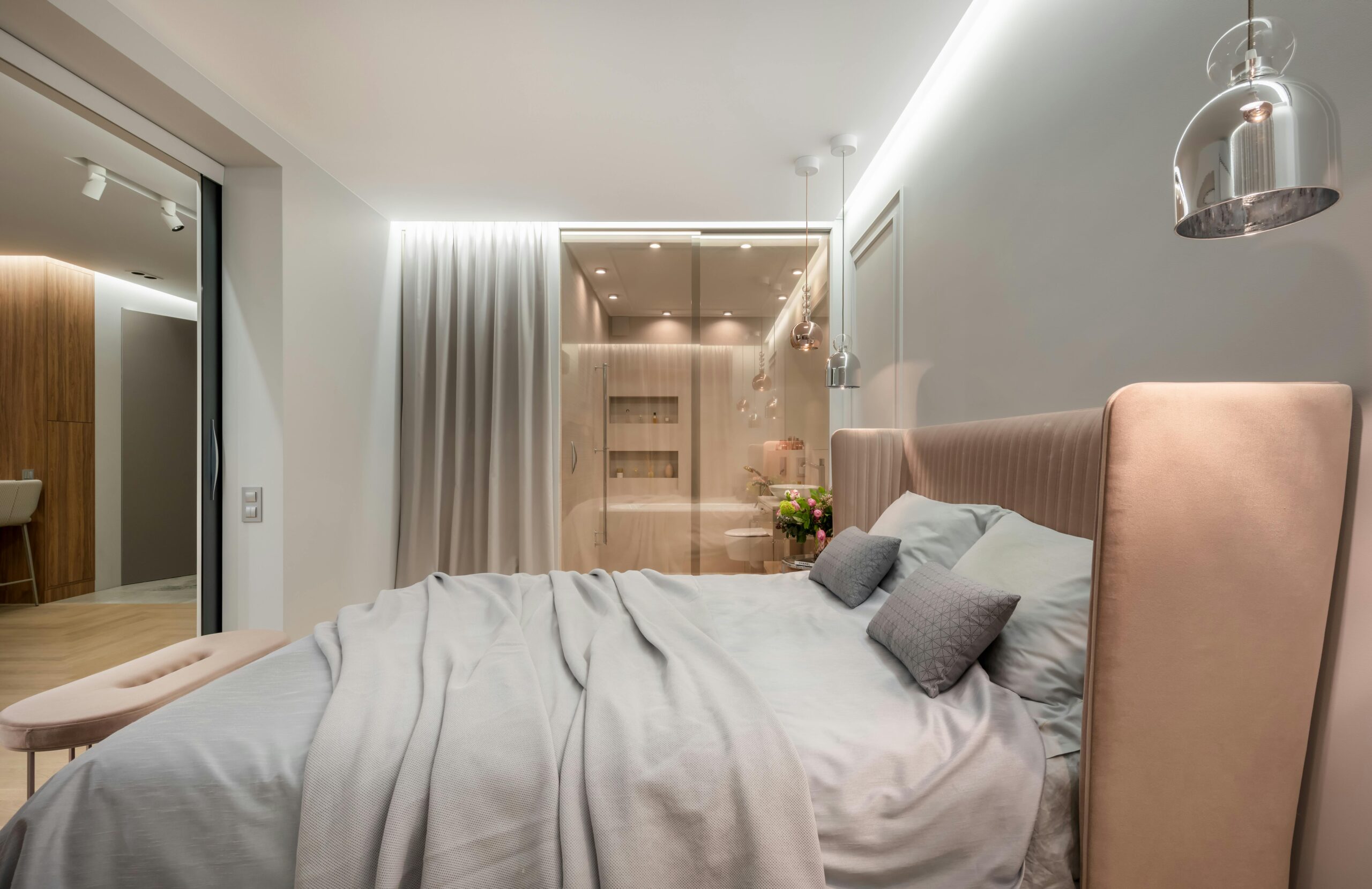 Urban Crest Interior of modern light bedroom with pillows and blanket on bed under lamps next to pouf near glass wall with curtain