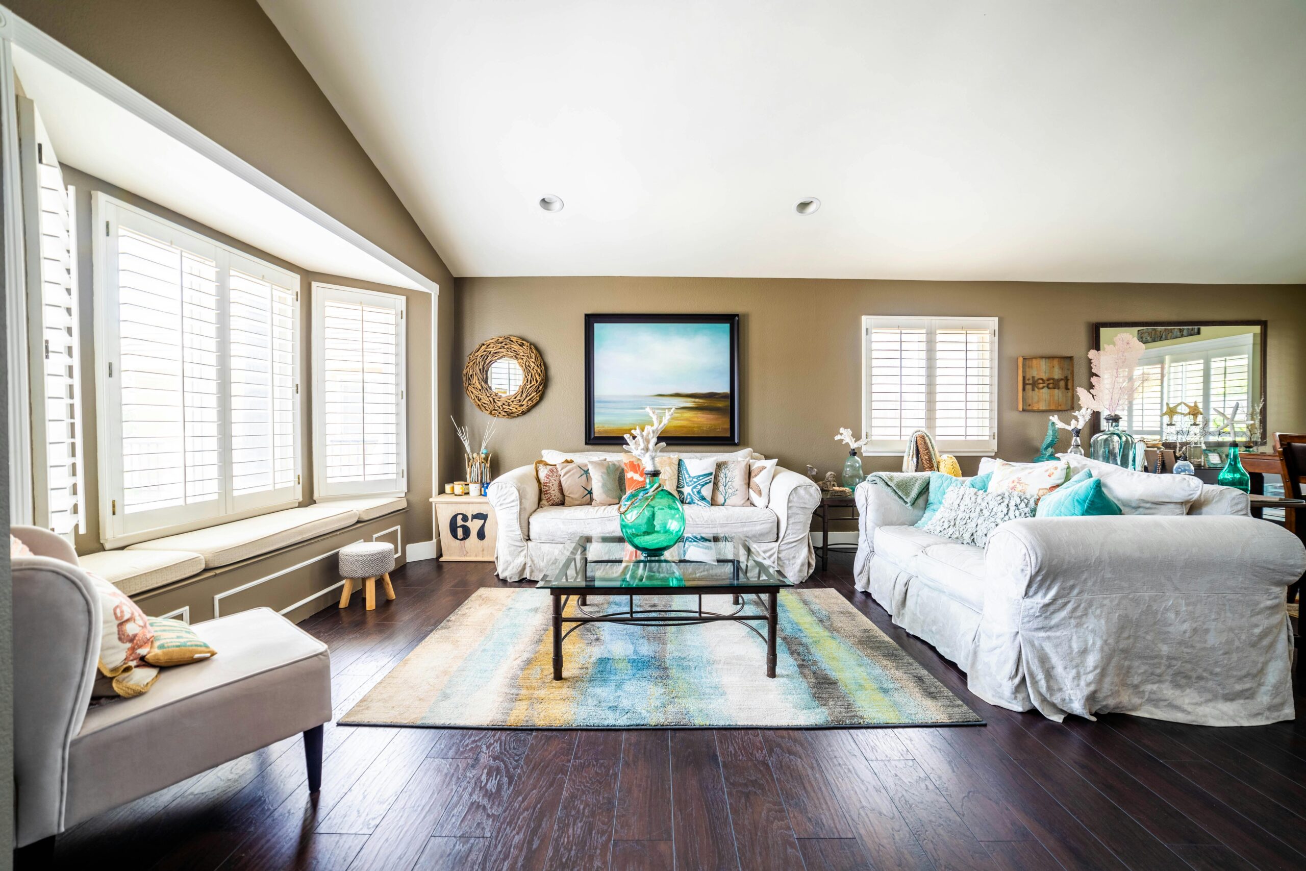 Inviting and stylish living room with white sofas and decorative accents, creating a cozy atmosphere.